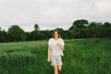 Wall Mural - Portrait Of Teenager Girl. Happy Cheerful Teen Girl With Pronounced Face dancing In Outdoors.