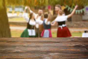 Poster - Drunk people dancing and celebrating Octoberfest outdoors