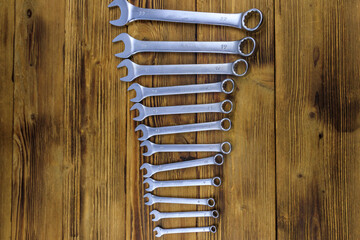 Wall Mural - Set of wrench tools on wooden background. Top view