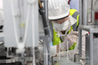 © feeling lucky - Caucasian mechanic technician maintenance, repairing industrial machinery equipment in factory. Professional worker in protective clothing with goggles and mask using wrench at manufacturing factory