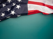 Top View Of The American Flag On A Green Background With Copy Space For Text