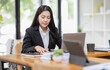 © David - Business Asian woman working with laptop computer and calculator document on an office desk, doing planning analyzing the financial report, business plan investment, finance analysis concept.