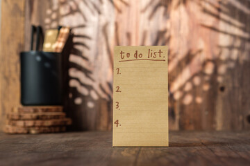 Poster - brown note paper to do list on wood wall and pencil box with sunlight