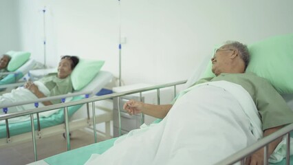 Wall Mural - Portrait of happy group of old elderly Asian patient or pensioner people smiling, relaxing, talking together on bed in nursing home. Senior lifestyle activity recreation. Retirement. Health care