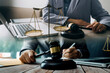© ARMMY PICCA - Male lawyer working with contract papers and wooden gavel on tabel in courtroom. justice and law ,attorney, court judge, concept.