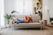 © Westend61 - Woman relaxing on sofa in living room at home