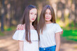 Two girlfriends teenagers in the summer forest. Close-up