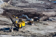 Panoramic aerial view of coal mine. Open pit mine industry, big yellow mining truck for coal quarry. Open coal mining anthracite mining. Pit on coal mining by open way. 