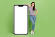 © deagreez - Full length body size view of beautiful cheerful girl demonstrating copy empty blank space isolated on bright green color background