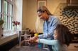 © Caia Image - Happy mother and daughter washing hands at kitchen sink