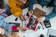 © Halfpoint - Group of high school students building and programming electric toys and robots at robotics classroom