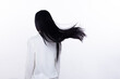 Black Straight Long Black Hair woman throw fly in air with fashion stylish and fun joy. Female turn back wear white shirt express emotion happy by blow wind hair, isolated white background