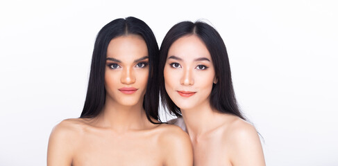 Two 2 Beautiful fresh skin women open shoulder with clean look make up and long black hair. Portrait young girls in attractive natural fashion face express feel smile, isolated white background