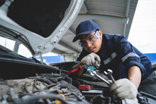 Asian Auto Mechanic Working On Car Engines Repair And Service Customer Service Work On The Engine In The Garage. Automobile Car Concept.