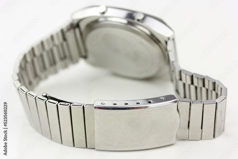 backside of a digital watch silver vintage retro wristwatch 70s 80s isolated alarm multifunctional chronograph scratched steel used made in japan rare worn on watch stand chronograph side view closeup