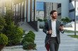 © Kostiantyn - Satisfied Businessman in suit going home after long working day and looking at side
