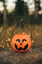Trick Or Treat Halloween Pumpkin Bucket With Festive Lights On The Background.