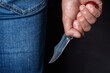 Man holding a knife in a threatening stance ready to fight