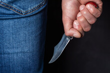 Man Holding A Knife In A Threatening Stance Ready To Fight