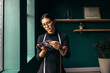 © Jacob Lund - Female tailor choosing the best fabric swatch