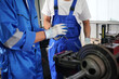 © FotoArtist - Workers changing and repair part of wheels at the car service