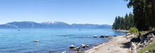 Panoramic View Of Rocky Beach And Dock At The Lake Surrounded By Mountains And Trees. Summer Season. Sugar Pine Point Beach, Tahoma, California, United States. Sugar Pine Point State Park. Panorama