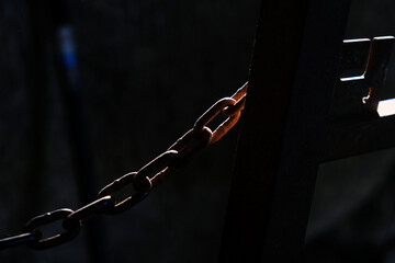 Poster - chain link metal in dark light.