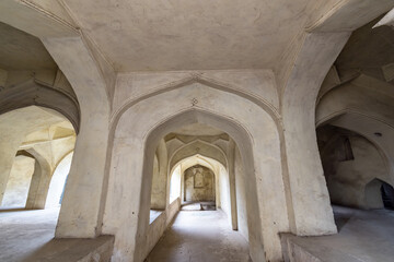 Sticker - The stone arches of a hall at the ancient historic heritage site of Golconda Fort in Hyderabad.