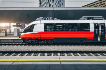 Wall Mural - high speed train on the railway station in vienna, austria. beautiful red modern intercity passenger