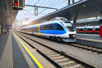 Wall Mural - high speed train on the train station at sunset in vienna, austria. beautiful blue modern intercity 