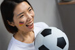 © WavebreakMediaMicro - Happy asian woman with football and flag of germany on her cheek