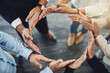 © Nola V/peopleimages.com - Circle of hands, teamwork and togetherness with a group of business colleagues standing in a team huddle from above. Working together, showing unity and giving support in a meeting for motivation
