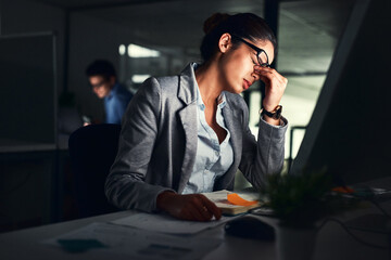 Poster - Stressed business woman working late on a computer in an office at night. Young worried entrepreneur feeling tired while struggling with burnout, eye strain and a headache from deadlines and pressure