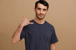 © SHOTPRIME STUDIO - Cheerful man smiling casual wear posing emotions beige background