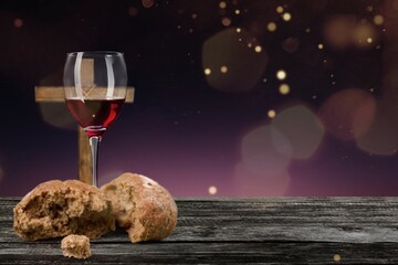 Wall Mural - Glass of wine, bread and cross on dark background. Holy Communion concept