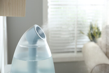 Wall Mural - Modern air humidifier at home, closeup view. Space for text