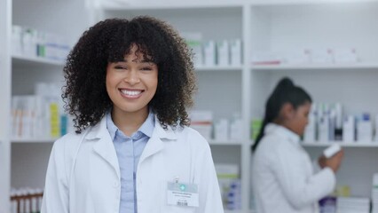 Canvas Print - Pharmacist, healthcare worker or medical student doctor smiling in a pharmacy. Young, happy and cheerful afro clerk standing with medicine and pills for patients pain, healing and wellness behind her