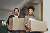 Fototapeta  - New house, moving and happy couple carrying boxes while feeling proud and excited about buying a house with a mortgage loan. Interracial husband and wife first time buyers unpacking in dream home