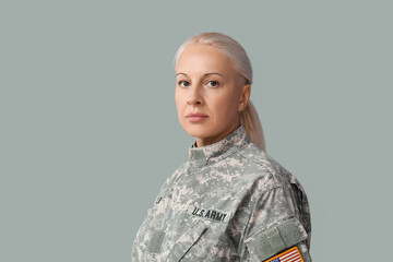 Mature female soldier on grey background