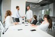 © Serhii - Confident and successful team. Group of people are working together in office. Blurred background