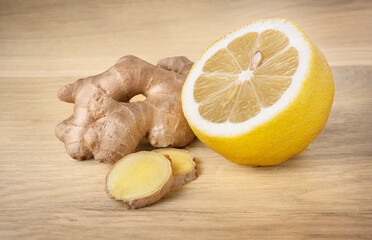 Ginger and lemon on wood background. Natural treat for cold and flu