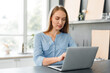 © fotofabrika - Young female entrepreneur working on a laptop at home