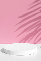 Wall Mural - Minimal abstract pink and white background for eco cosmetic product presentation. Cylindrical white scene. Premium podium with a shadow of tropical palm leaves. Empty showcase.