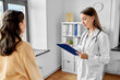 © Syda Productions - medicine, healthcare and people concept - female doctor with clipboard talking to woman patient at hospital