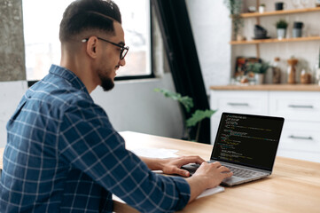 side view of a programmer with laptop. clever successful guy, an it specialist, software developer, 