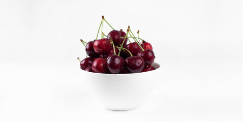 Wall Mural - Sweet cherry. Cherries in a bowl. On a white background.