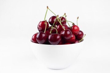 Wall Mural - Sweet cherry. Cherries in a bowl. On a white background.