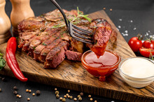 Fried Medium Rare Marble Steak With Sauce On Wooden Background