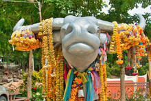 Head Of A Giant Silver Buffalo, Decorated With Flower Garlands, On The Grounds Of The Wat Pra Putthabat Phu Kwai Ngoen Or Rabbit Temple, Chiang Khan, Province Of Loei, Thailand
