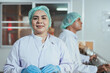 © Supachai - Senior female employee worker in uniform working clean and check for dirt glass bottles for juice drinks in beverage factory industry